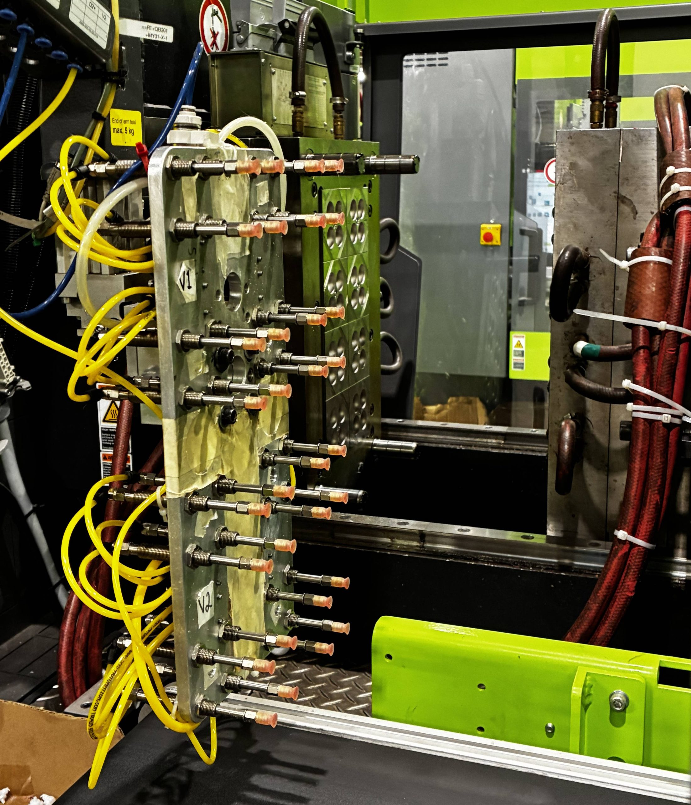 A robotic arm used to unload molded plastic parts from the injection molding machine