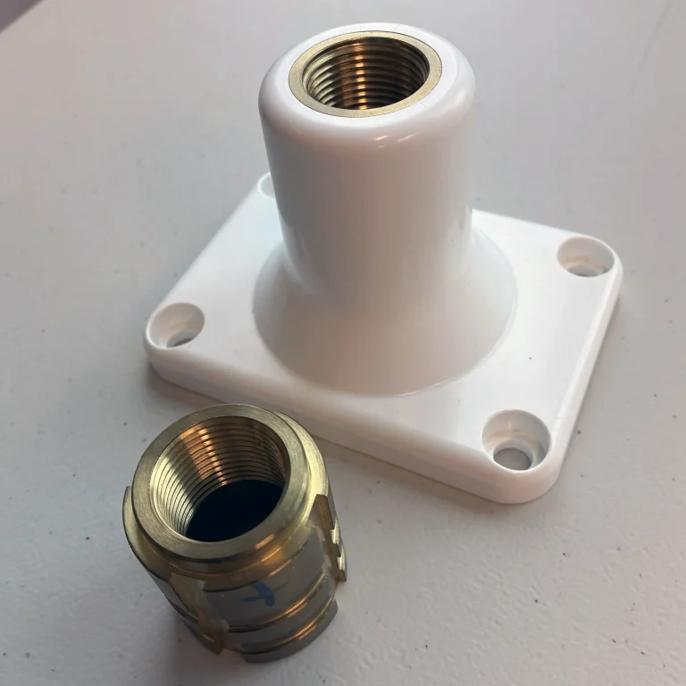 Antenna mount overmolded with brass core.